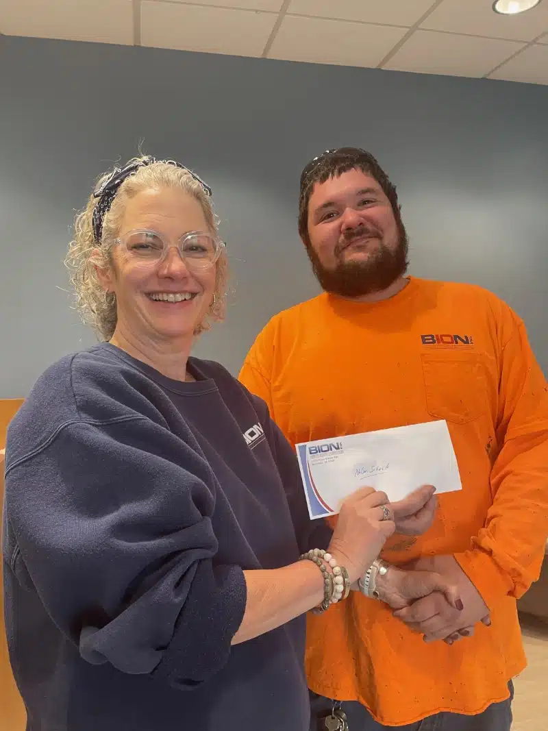 man and women shaking hands holding letter